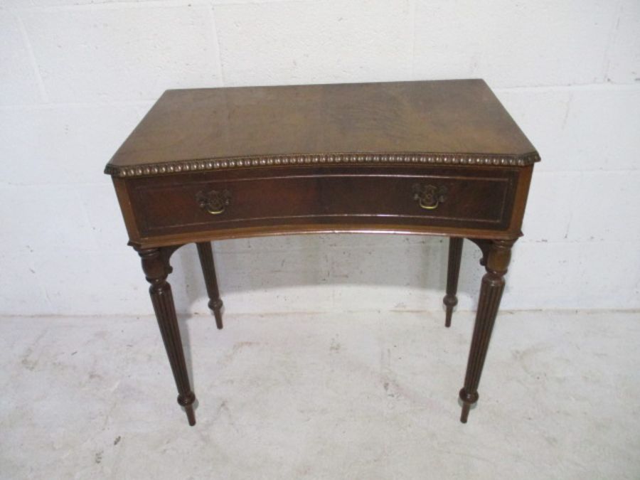 A hall table with single drawer on fluted legs