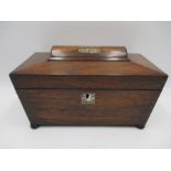 A Victorian rosewood tea caddy inlaid with mother of pearl