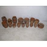 A collection of various sized terracotta garden pots