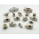 A collection of Crested Ware including a number of pigs, loving cup, boat containing salt and pepper