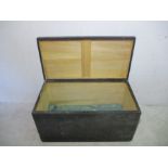 A wooden black storage trunk