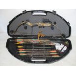 A Fred Bear "Quest" compound bow with arrows and hard carry case