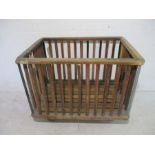 An industrial slatted wooden bobbin trolley