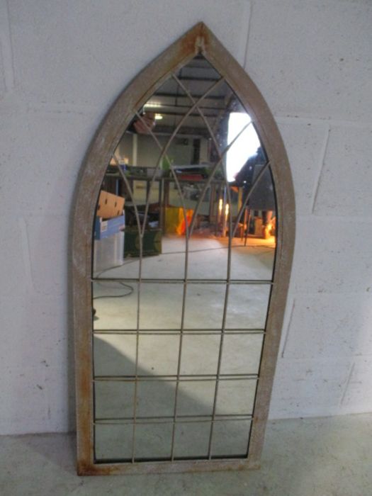 A metal framed Gothic style mirror