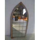 A metal framed Gothic style mirror