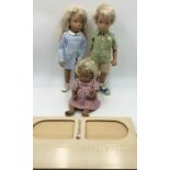 Two Sasha dolls, a blonde girl in gingham dress and a blonde boy in shorts and t-shirt with mouse in