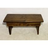 A small oak bench with lift up lid