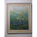 A framed oil painting of flowers in a meadow signed Fuchs