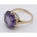 An 18ct gold ring set with large central amethyst