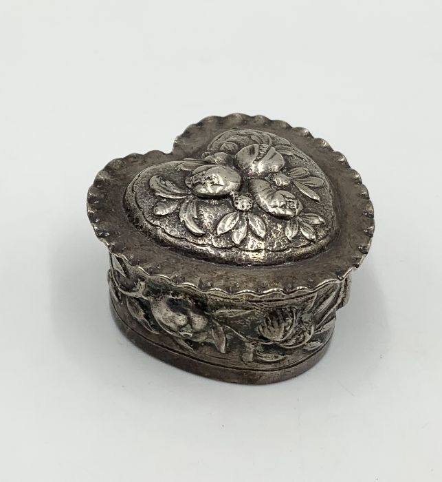 A hallmarked silver heart shaped lidded pot with floral decoration