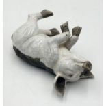 A Raku glazed Studio pottery pig, signed Brian Andrew, in recumbent pose with crackle glaze,