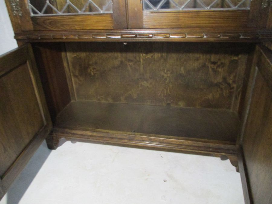 An oak display cabinet with linen fold decoration and cupboard under - Image 11 of 13