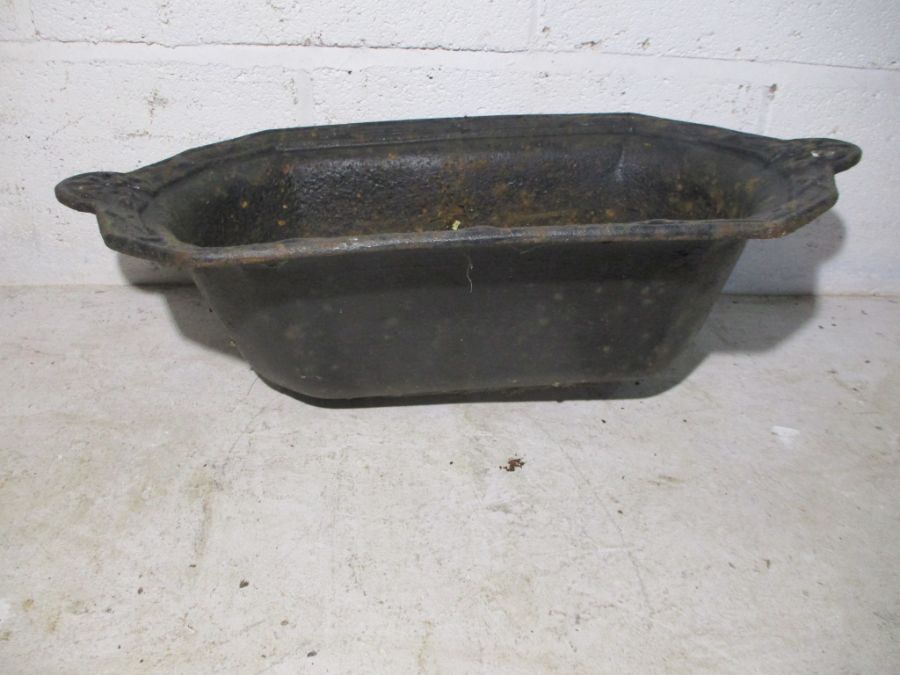 A Victorian cast iron trough. Length 63cm.