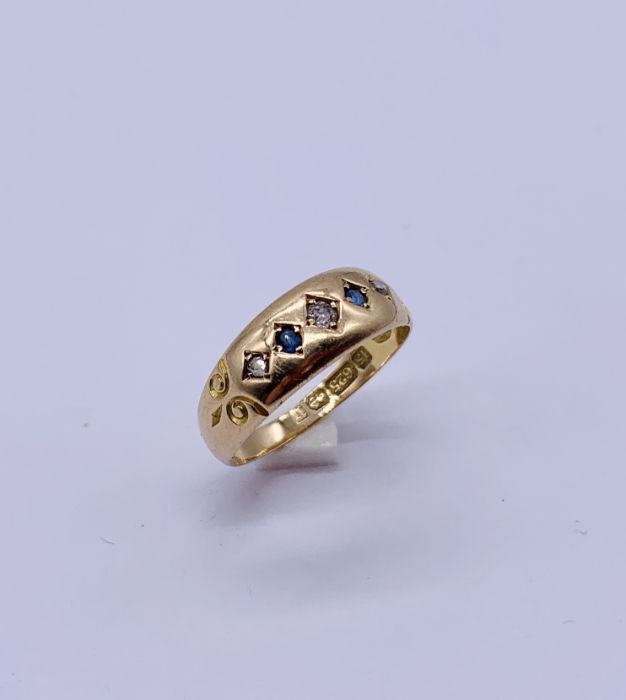 A 15ct gold gypsy set ring with diamonds and sapphires