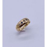 A 15ct gold gypsy set ring with diamonds and sapphires