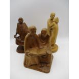 Three hand carved wooden sculptures by Tim Earl, including a dancing monk, two monks reading