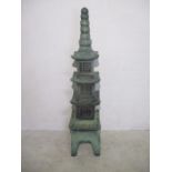 A four tier green painted concrete pagoda