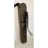 A large vintage water pump mounted on a wooden plinth. Height 162cm, Width 25cm and Depth 27cm