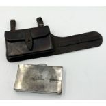 A war era leather pouch with fitted metal box designed to attach to a belt. Marked for The Army &