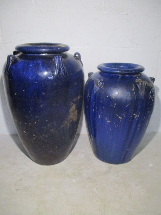 Two large glazed blue garden urns.