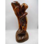 An abstract wooden sculpture entitled "Genesis" by Tim Earl - overall height approx. 58cm