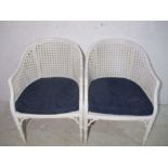 A pair of painted bamboo chairs.