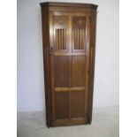 An oak single wardrobe with linen fold decoration.