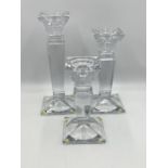 A set of three graduated glass candlesticks (smallest one chipped to corner of base)