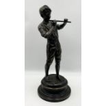 A bronze statue of a young boy playing the flute by Fonderia Lancini, signed to the foot and to