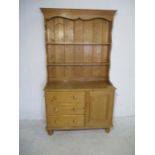 A pine dresser with three drawers and one cupboard under