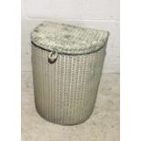 A Lloyd Loom laundry basket and similar style chair