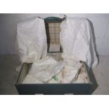 A small collection of vintage linen in a suitcase