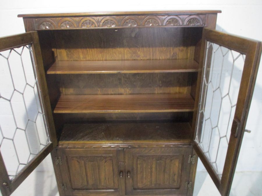 An oak display cabinet with linen fold decoration and cupboard under - Image 12 of 13