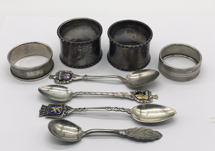 Four hallmarked silver napkin rings along with four continental silver spoons