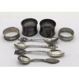 Four hallmarked silver napkin rings along with four continental silver spoons