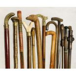 A selection of various walking sticks etc including a brass handled collapsible stick with concealed