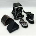 A Mamiya C3 Professional camera along with two additional lenses and a Mamiya Porroflex in leather