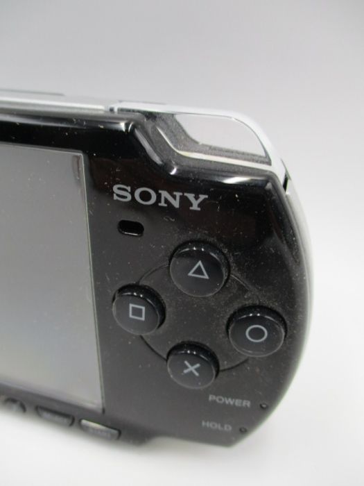 A boxed Sony PSP-2003 Piano Black handheld console with charger, along with four PSP games ( - Image 6 of 10