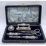 A hallmarked silver manicure set- box in need of attention