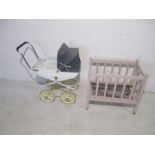 A vintage child's pram and wooden framed cot