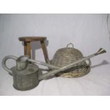 A Haws galvanised watering can, milking stool and wicker tray and cover