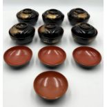 A collection of Oriental lacquer bowls in black, gold and red.