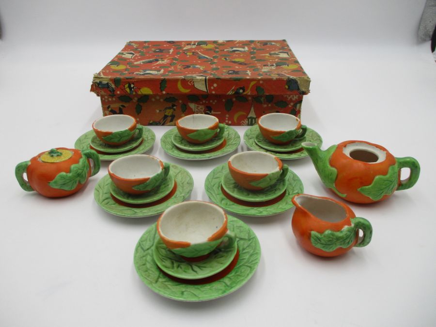 A child's vintage miniature tea set, pumpkin themed, marked "golden series rec. foreign". In a