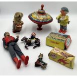 A small collection of toys including two vintage clockwork toys