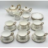 A Royal Crown Derby "Vine" tea set comprising of six trios, teapot, creamer, milk jug and sugar