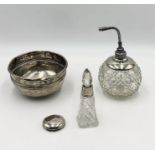 A hallmarked silver bowl A/F along with two silver collared cut glass scent bottles
