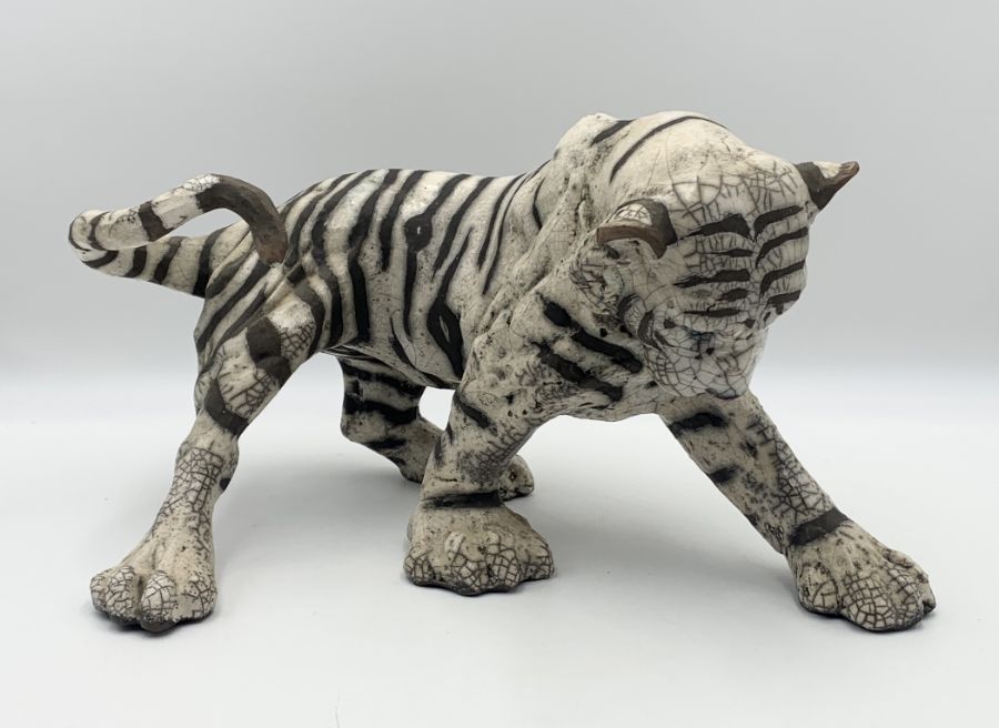 A Raku pottery model of a tiger signed K Rudge