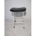 A retro metal framed stool with vinyl seat