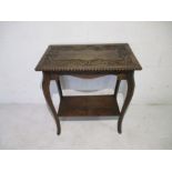A carved oak occasional table with acorn motif