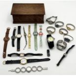 A collection of various watches in a wooden box